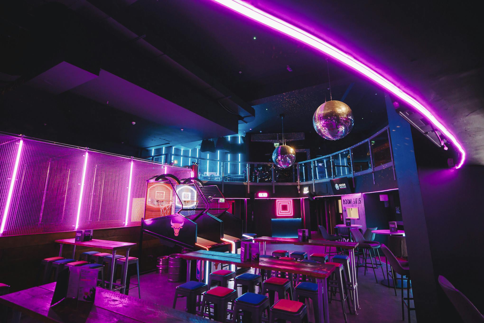 Vibrant event space with neon lights for private hire in Boom Battle Bar Manchester.