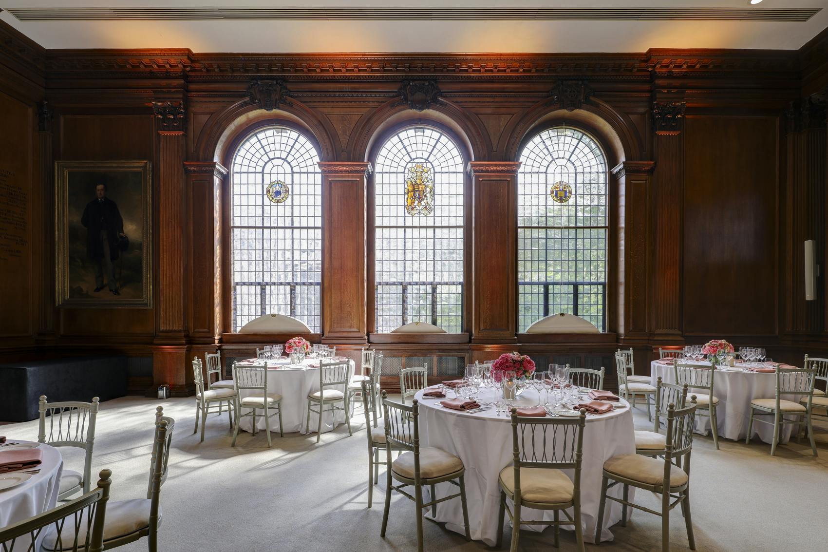 Elegant lecture hall with round tables, perfect for corporate meetings and upscale events.