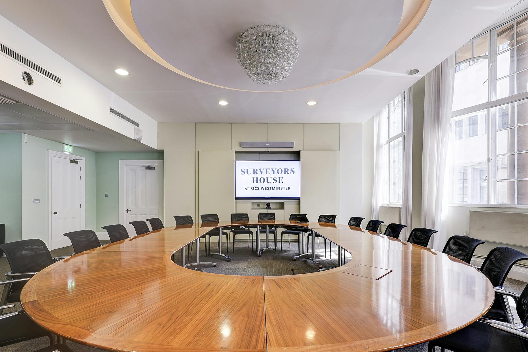 Modern conference room in Brussels with oval table, ideal for meetings and brainstorming.