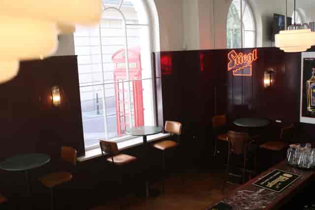 Charming bar area with wooden accents for cozy networking events at The Bolter.