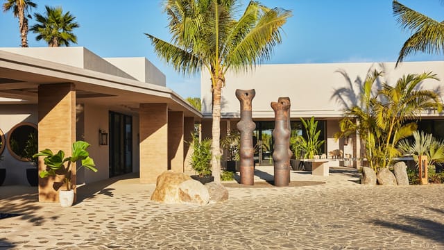 Modern venue entrance with sculptures, ideal for networking events and gatherings.