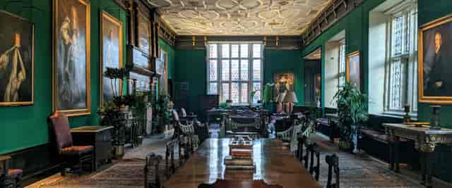 Great Chamber in The Charterhouse, elegant green walls, ideal for meetings and events.