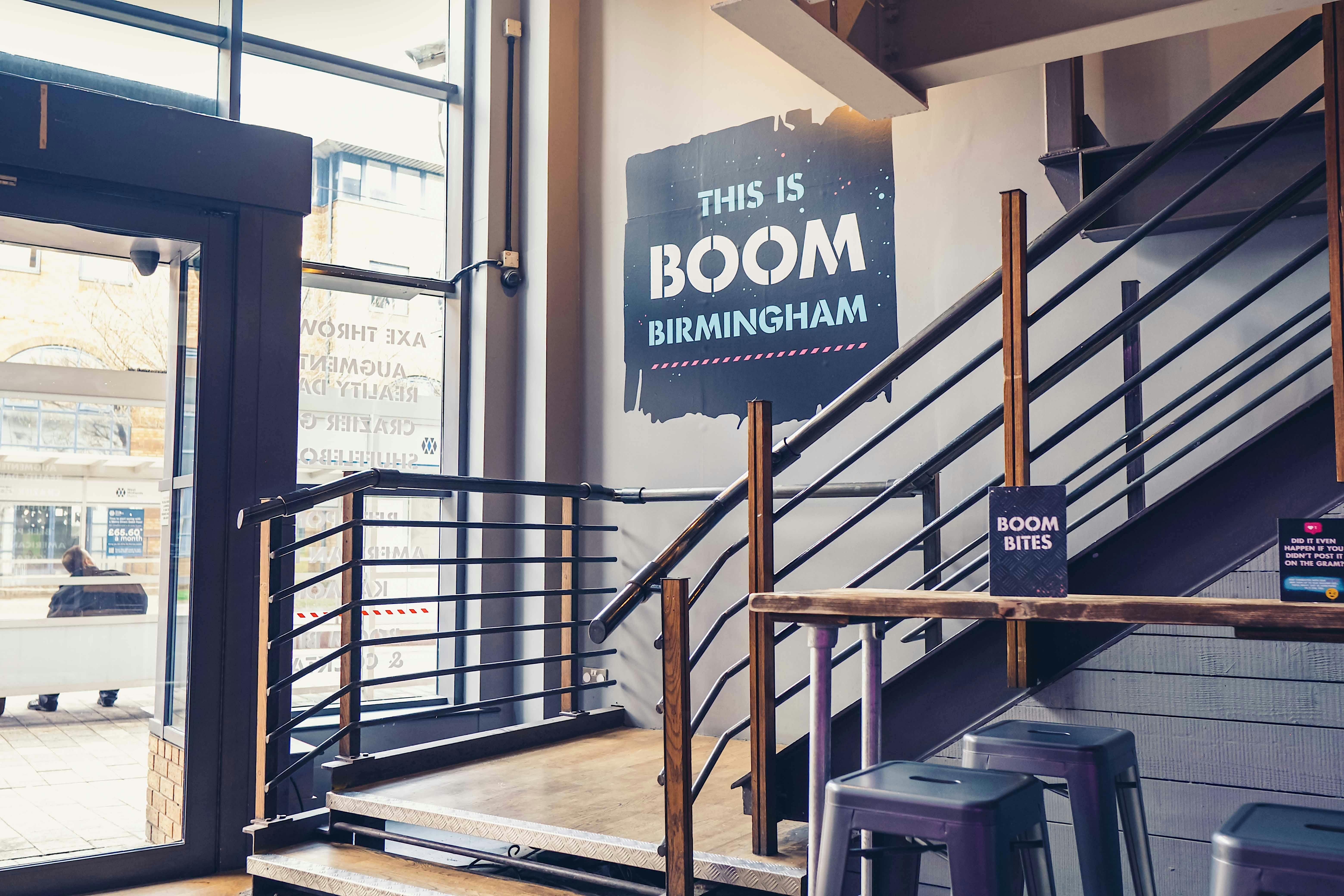 Party Packages at Boom Battle Bar Birmingham, modern entrance with inviting staircase, event venue.