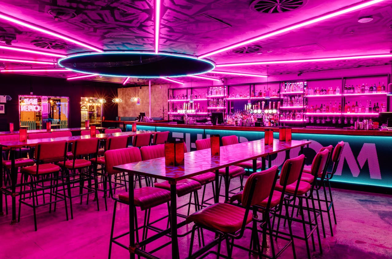 Exclusive private hire event space with pink neon lighting at Boom Battle Bar O2.