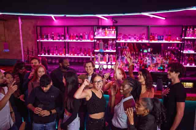 Vibrant private hire event at Boom Battle Bar O2 with colorful lighting and lively atmosphere.