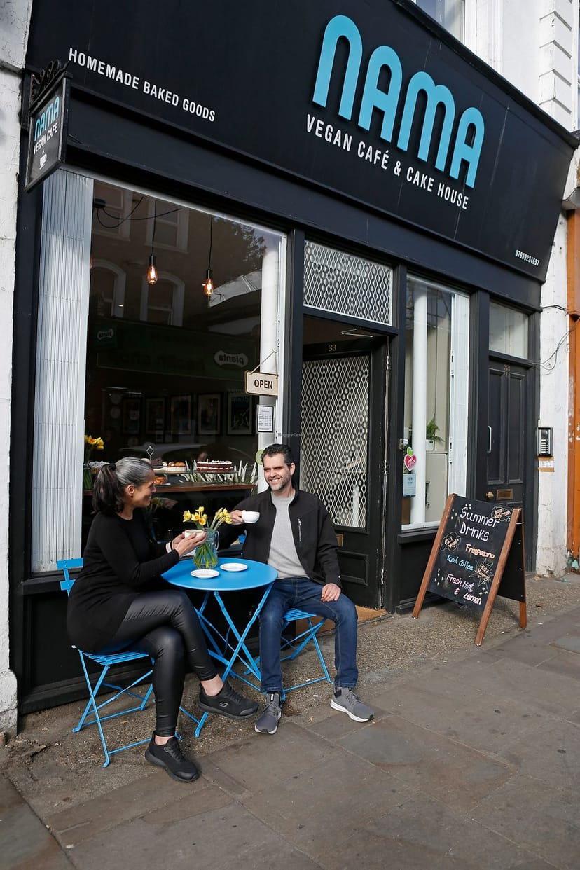 Cozy outdoor café with blue tables, perfect for casual meetings and networking events.