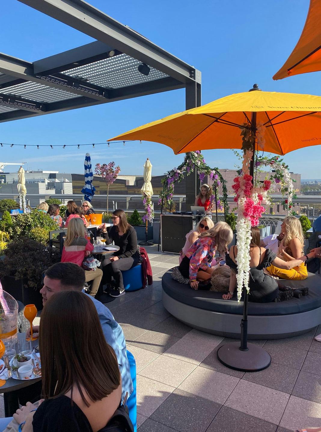 Vibrant rooftop pizza restaurant with colorful decor, perfect for social events and networking.