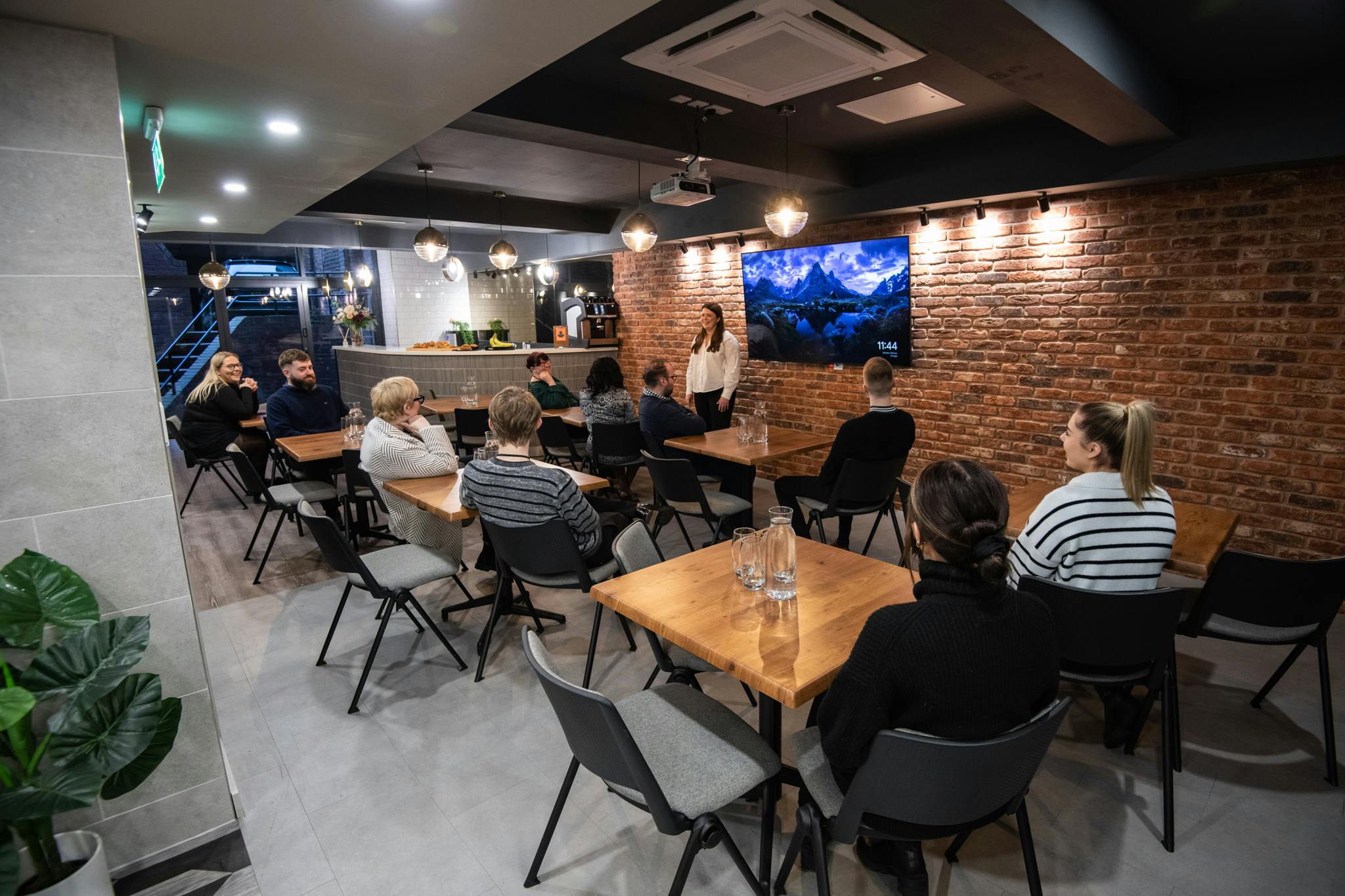 Park Place Event Space with brick wall, ideal for workshops and team meetings.