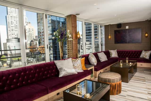 Stylish enclosed skybar lounge with city views, perfect for upscale events and gatherings.