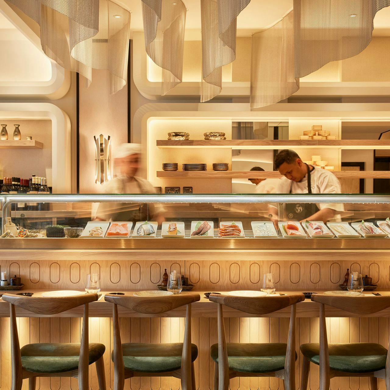 Modern sushi bar with chefs, ideal for intimate culinary events and tastings.