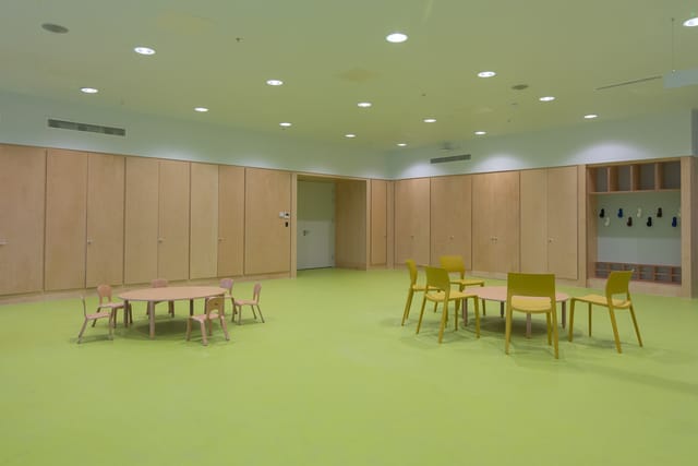 Versatile meeting space in Una Marson Library with vibrant green floor for workshops.
