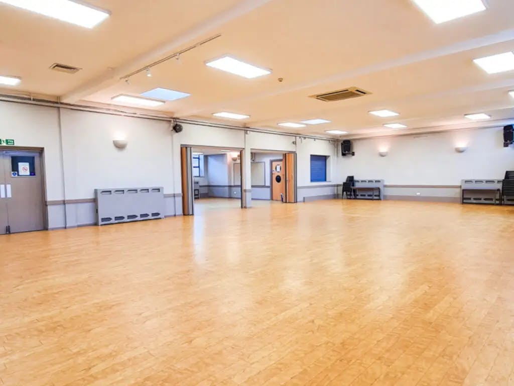 Spacious Arkley Village Hall event room with polished wooden floor for meetings and workshops.