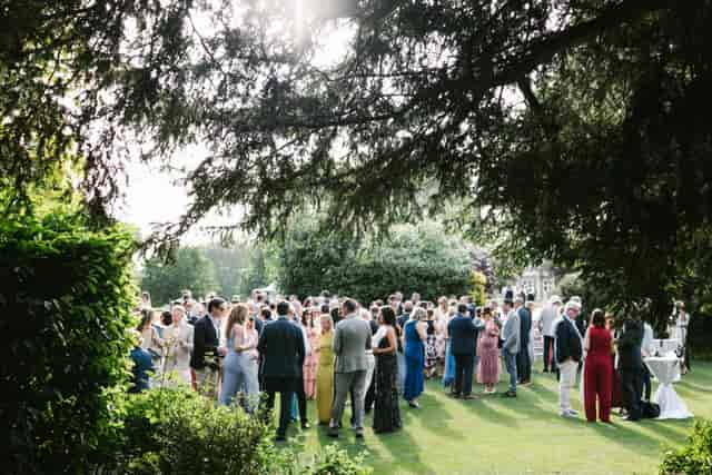 Outdoor cocktail reception at The Hurlingham Club with shaded canopy for corporate events.