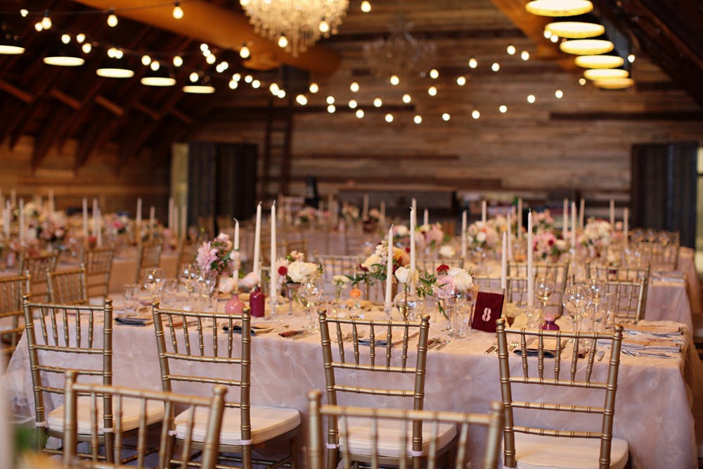 Elegant banquet setting in Bull Barn, rustic venue for weddings and upscale events.