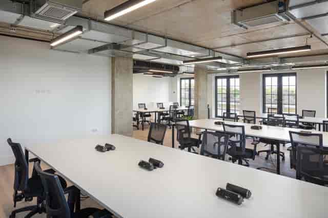 Modern private office meeting space with AV tech for collaboration and networking events.