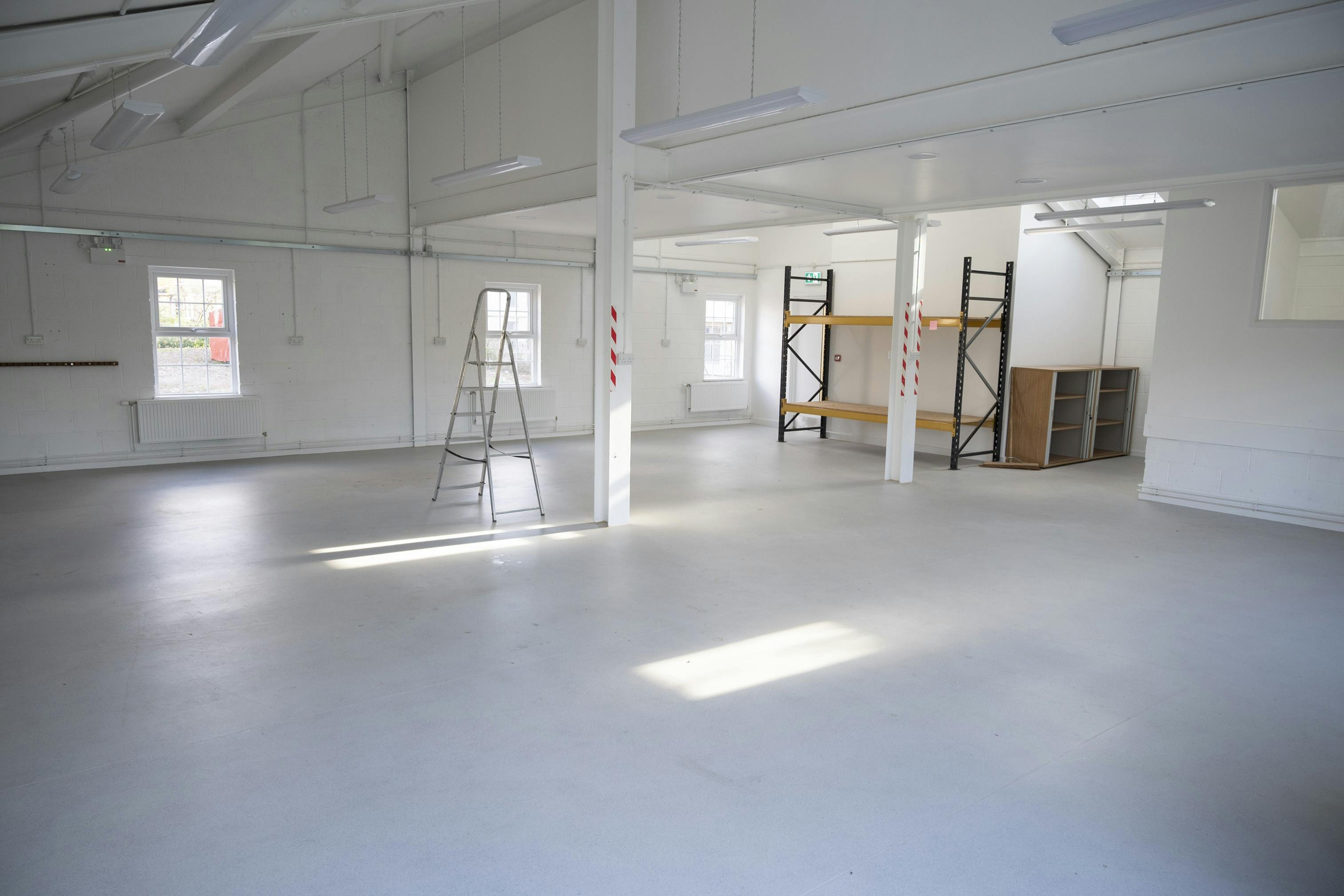 Versatile event space with high ceilings, ideal for meetings and workshops.