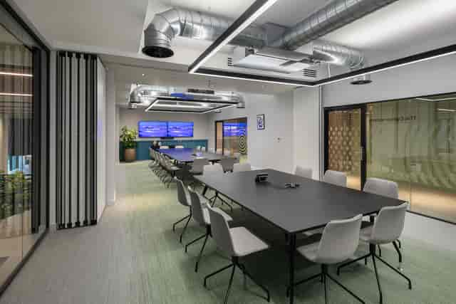 Modern conference room with large table and ergonomic chairs for productive meetings.