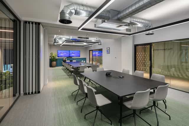 Modern conference room with large table and ergonomic chairs for productive meetings.