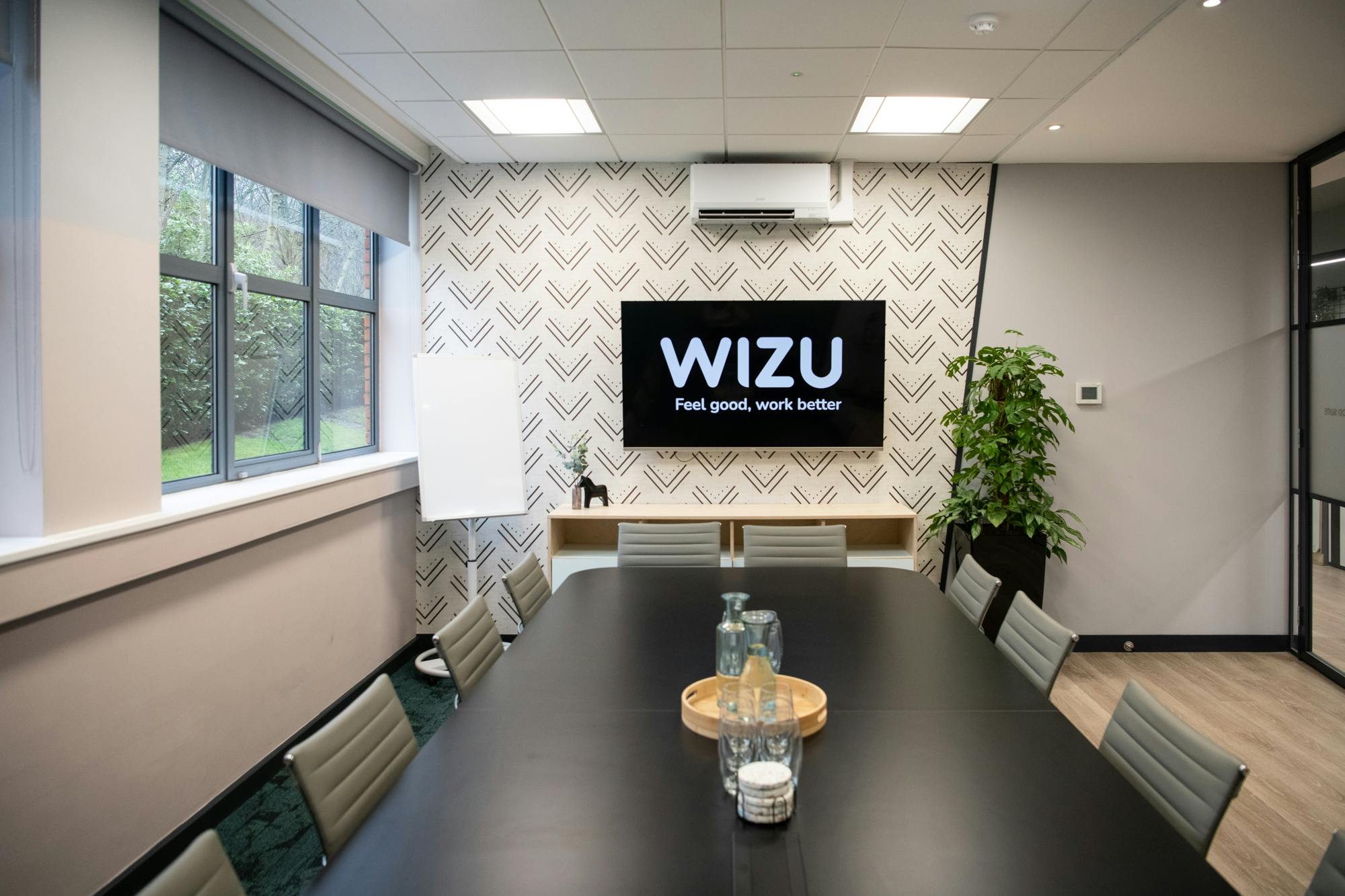 Modern meeting room with sleek black table for productive brainstorming sessions.