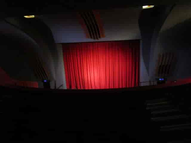 Red curtain stage in Rio Cinema, perfect for impactful performances and engaging events.