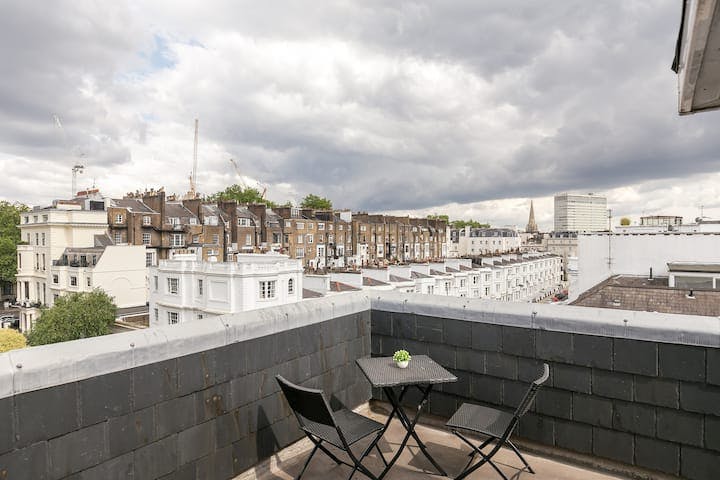 Rooftop terrace with table and chairs, ideal for networking events in London.