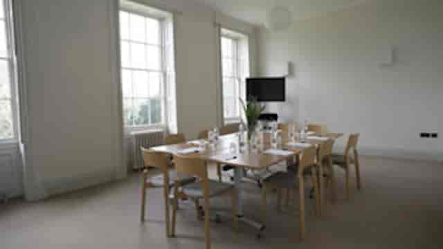 Well-lit meeting room with minimalist decor, perfect for workshops in Hackney Venues.