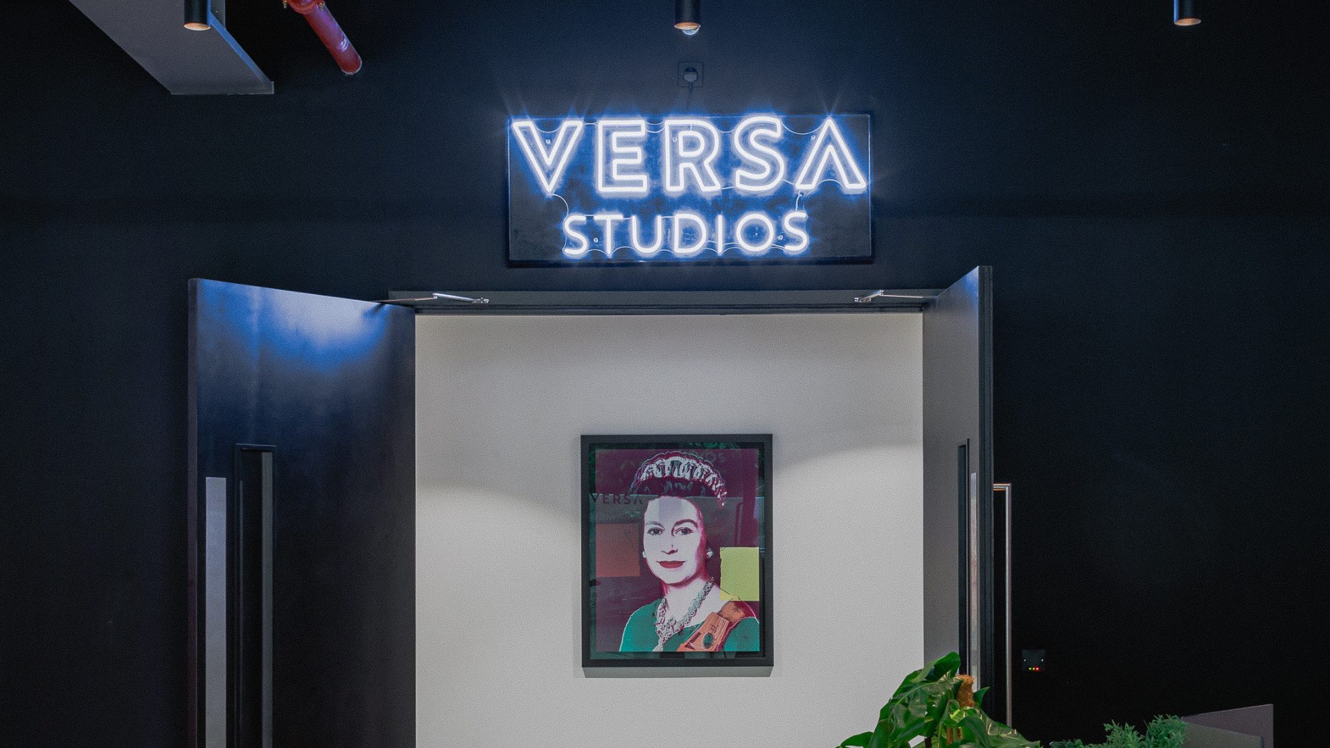 Modern entrance of VERSA Studios with neon sign, ideal for creative events and meetings. - Banner