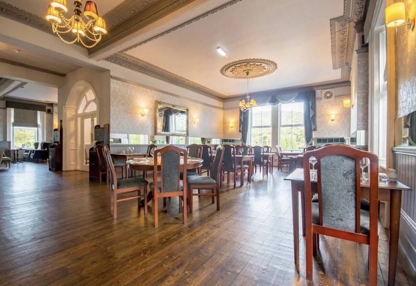 Elegant event space in Armstrong Manor with wooden flooring for corporate and social gatherings. - Banner