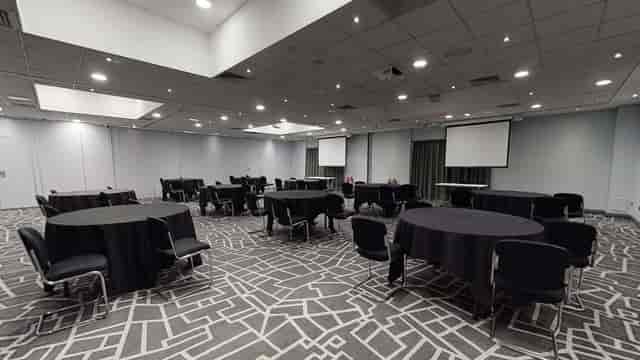 Meeting room at Village Hotel Bury, featuring round tables for conferences and events.