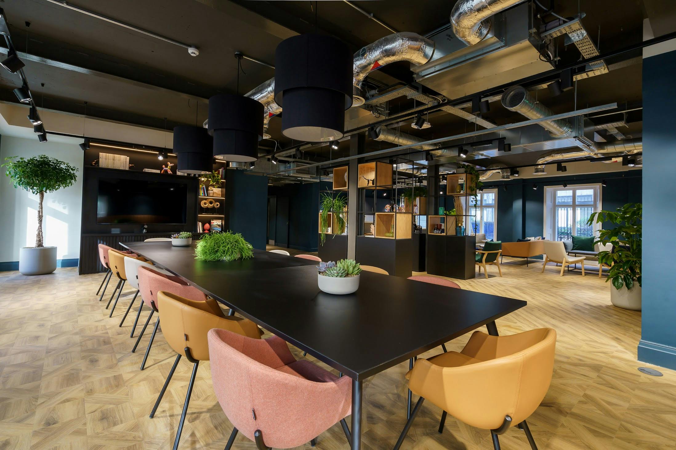 Modern meeting space with sleek table and natural light for creative events in Portland House.