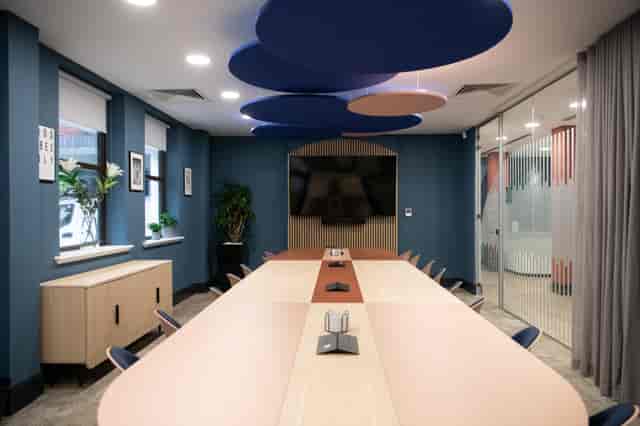 Modern Millennium Suite boardroom with tech table for hybrid meetings and workshops.