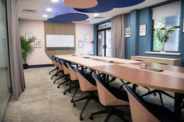 Modern boardroom at Millennium Suite Wizu Workspace for professional client meetings.