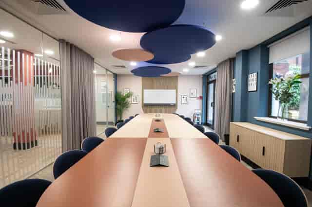 Modern Millennium Suite boardroom with dual-tone table for executive meetings and workshops.