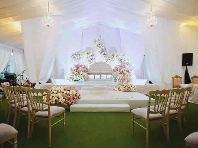 Chandelier Ballroom event space with elegant stage, ideal for weddings and upscale gatherings.
