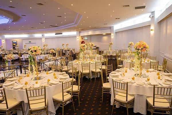 Elegant event space with floral centerpieces, perfect for weddings and formal gatherings.