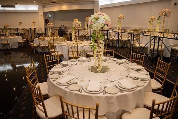 Elegant Pearl Ballroom with white linens, ideal for weddings and corporate events.