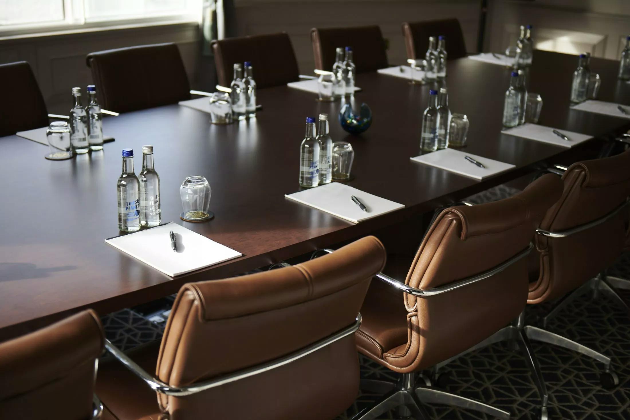 Boardroom at The Castle Hotel Windsor with long wooden table, ideal for conferences.