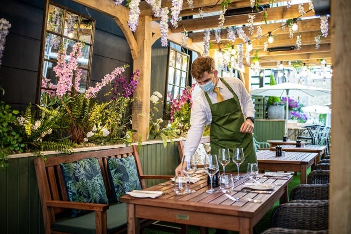 Outdoor dining setup at The Castle Hotel Windsor with vibrant floral decor for events.