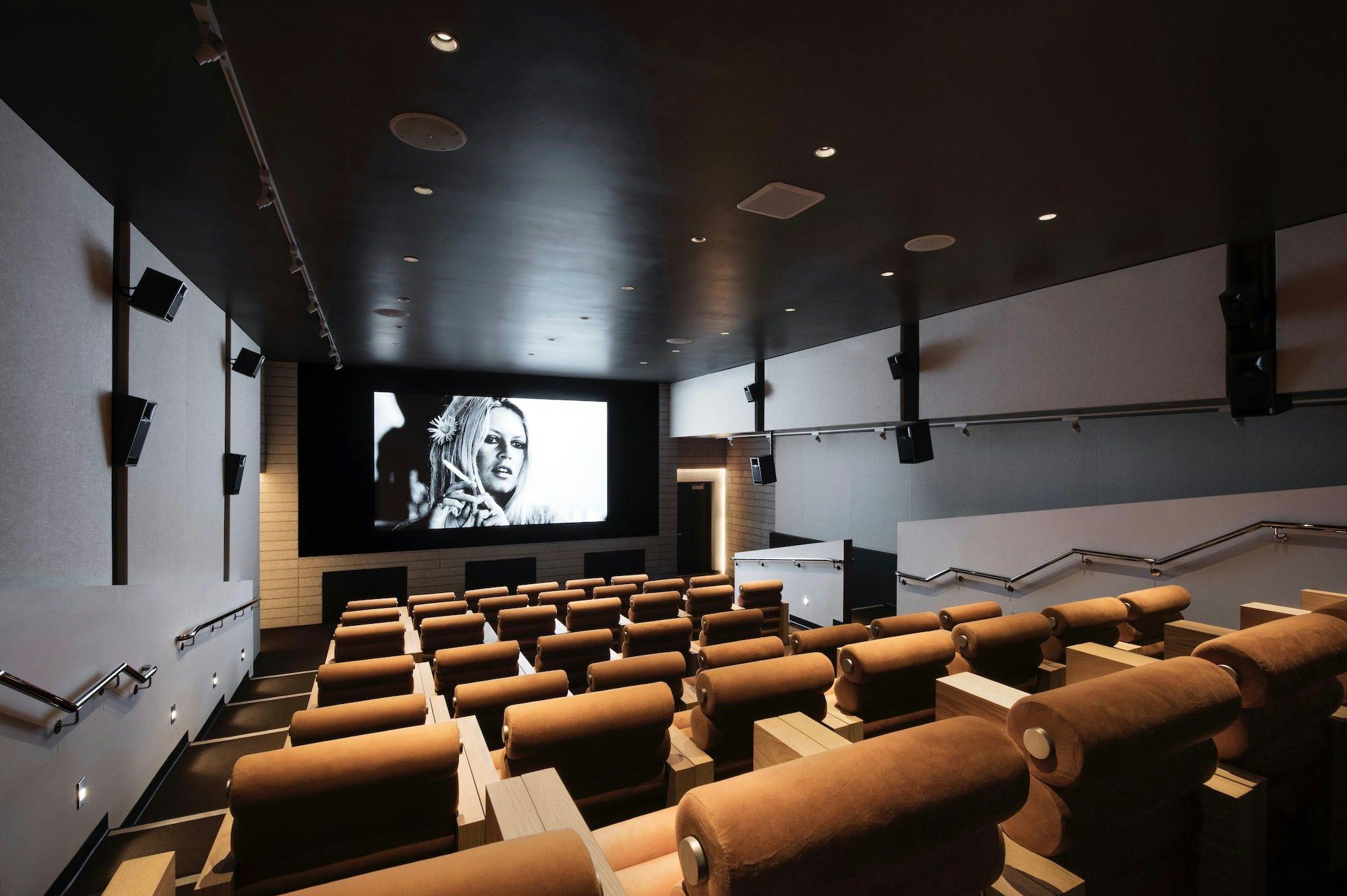 Modern screening room with tiered seating for film screenings and corporate presentations.