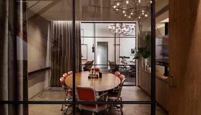 Modern podcast room with round table, ideal for meetings and brainstorming at NeueHouse.