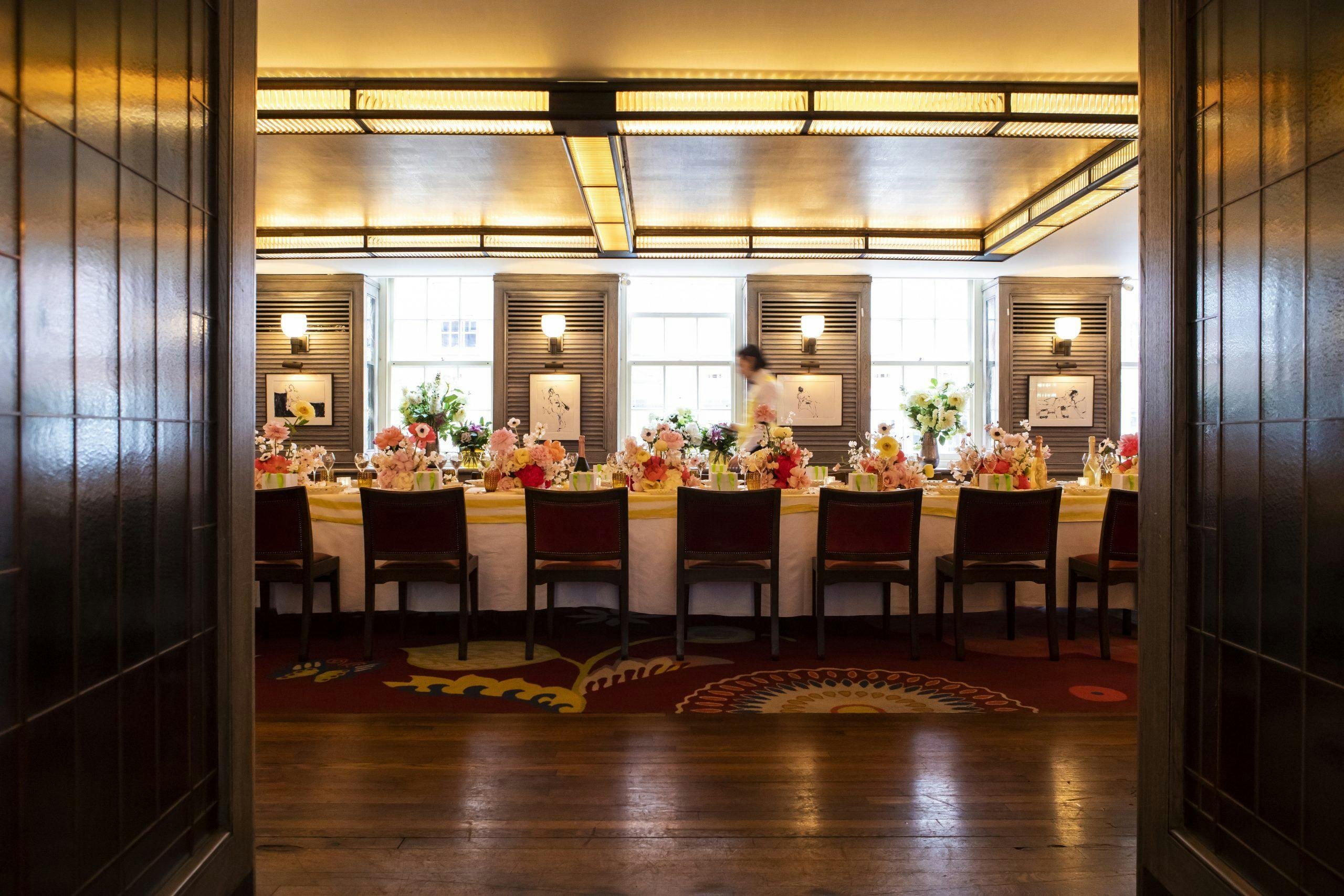 Elegant dining setup with floral centerpieces for networking event at The Emin.