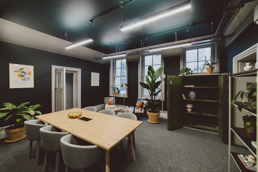 Modern meeting room with wooden table, ideal for collaborative brainstorming sessions.