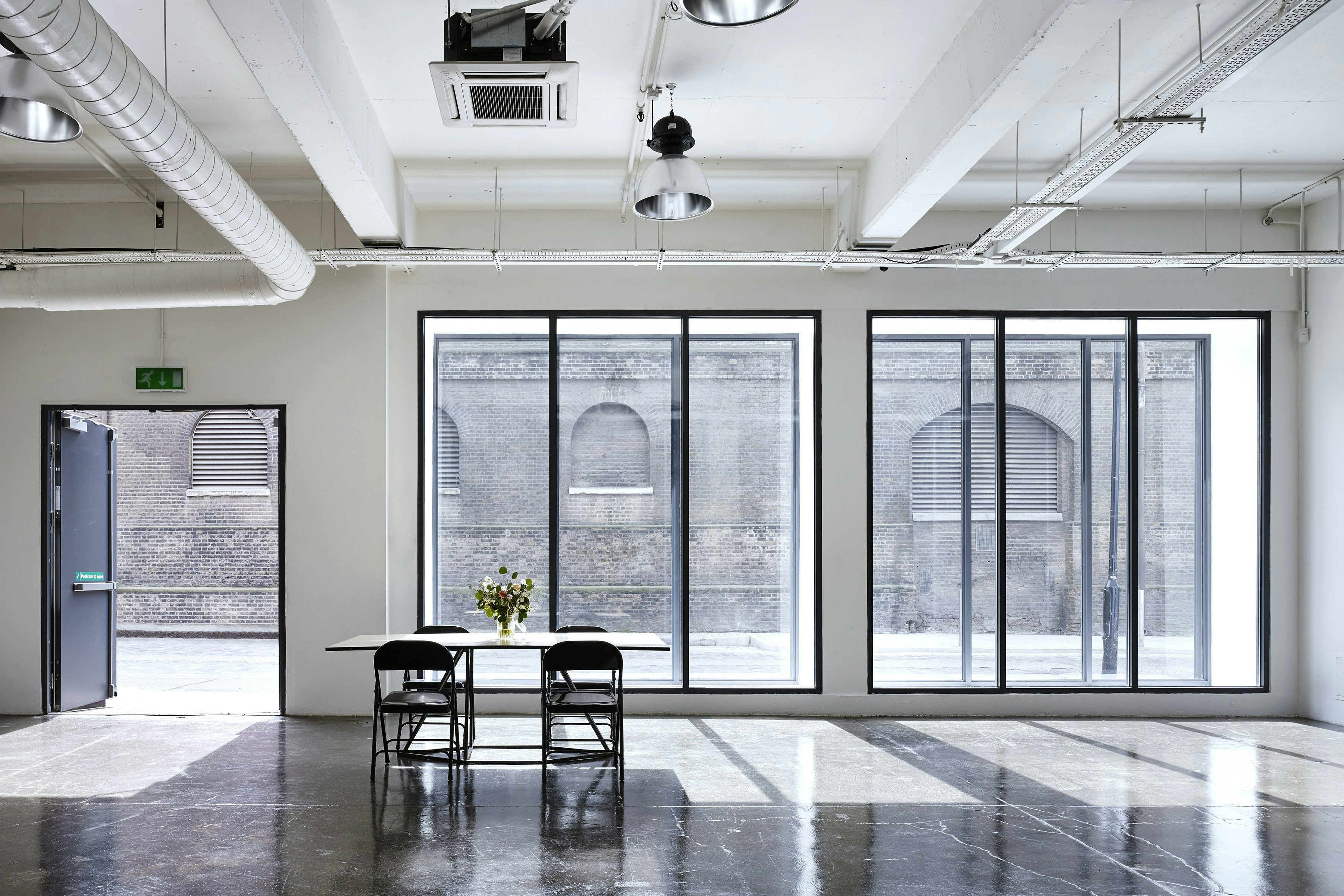 Modern meeting room with large windows, perfect for workshops and events. - Banner