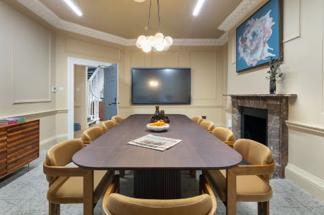 Meeting room at Canopy Elmtree with wooden table, ideal for professional gatherings.