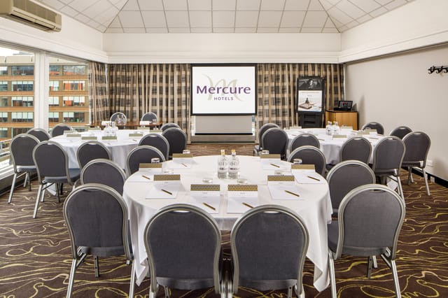 Corporate meeting room with circular table at Mercure Manchester Piccadilly Hotel.