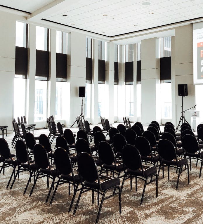 Event space at Vue on 50, featuring black chairs and natural light for seminars.