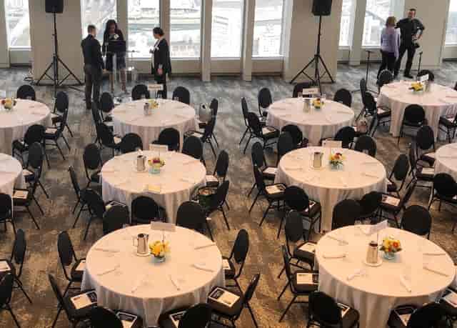 Elegant event space with round tables, ideal for conferences and formal gatherings.