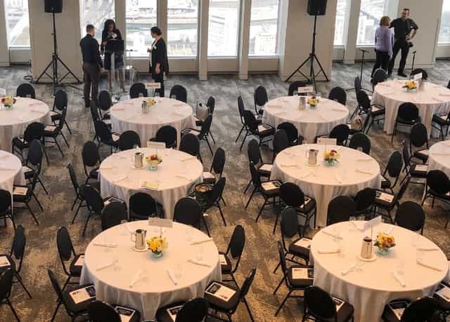Elegant event space with round tables, ideal for conferences and formal gatherings.