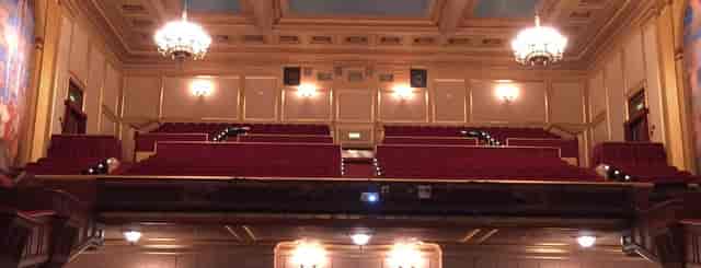 San Francisco Community Music Center auditorium with elegant chandeliers and plush seating.