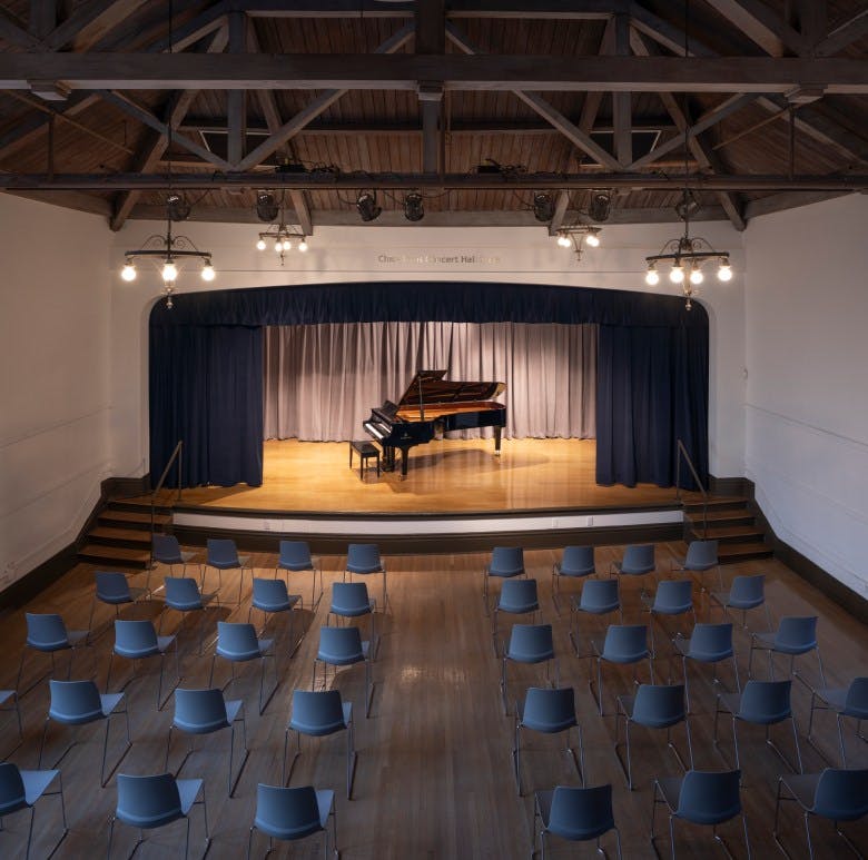 Grand piano on stage in CMC Piano Lab, ideal for concerts and recitals.